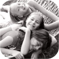 young girls laughing on hammock